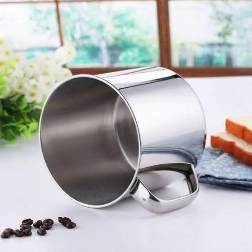 Stainless steel camping mug with lid on white background