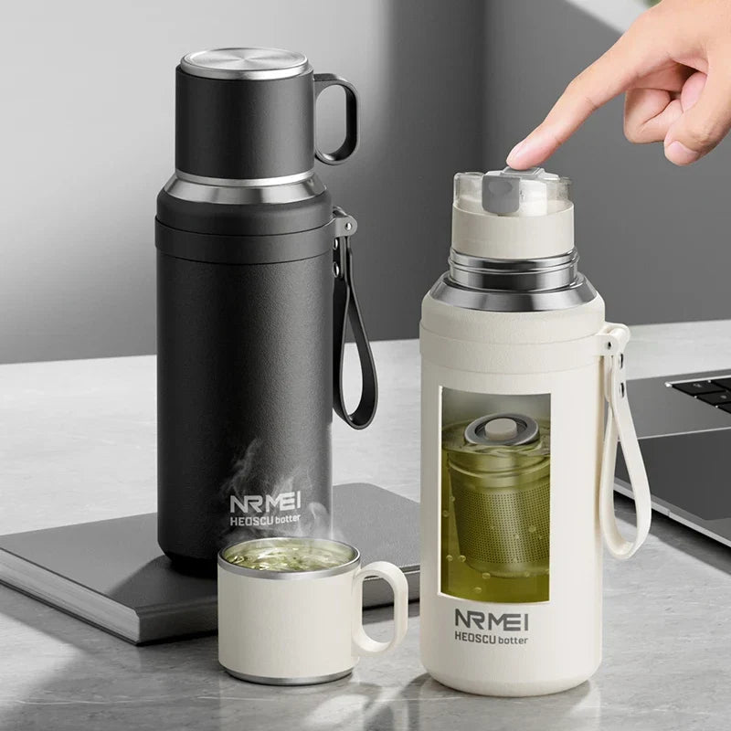 Black insulated tea thermos with magnetic infuser on wooden table