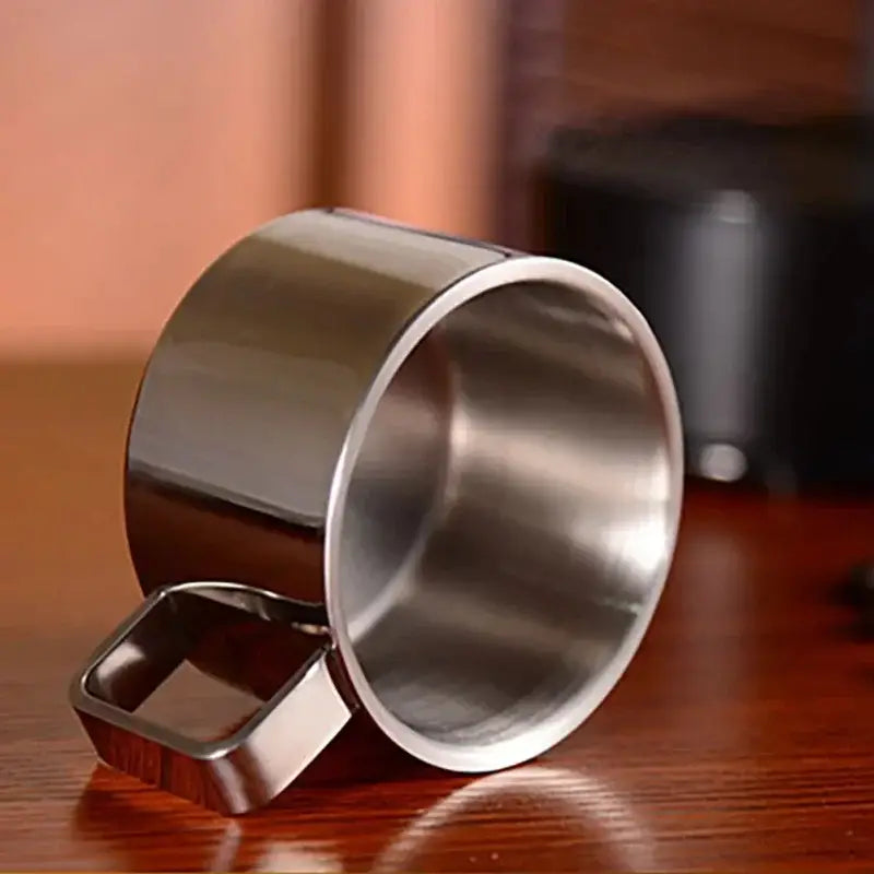 Stainless steel saucer and cup on kitchen counter