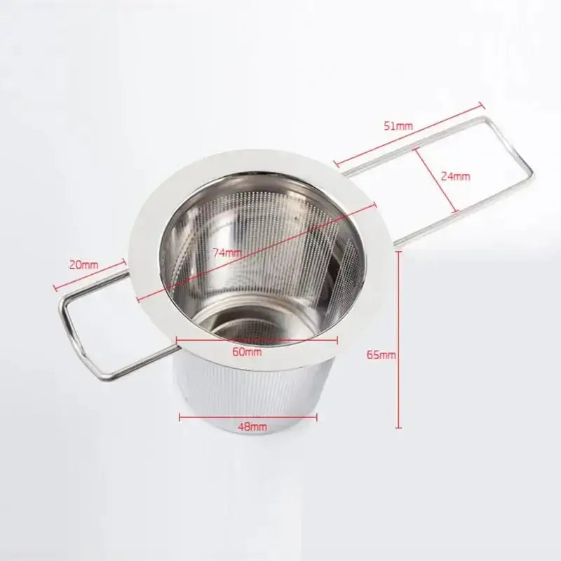 Tea infuser ball steeping in a clear glass mug of hot water