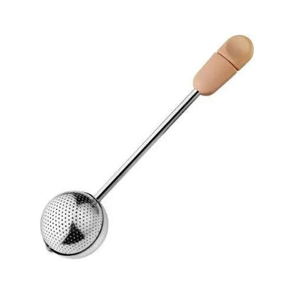 Rose pink stainless steel tea infuser ball with Magic Handle on wooden surface