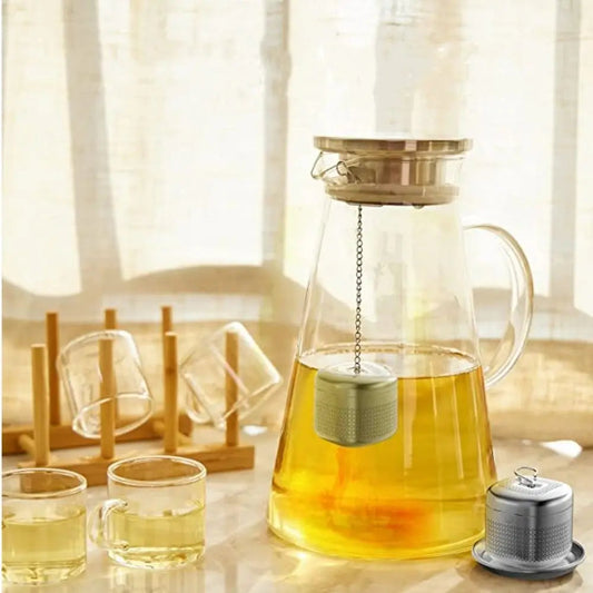 Stainless steel cube infuser inside a mug with loose leaf tea steeping