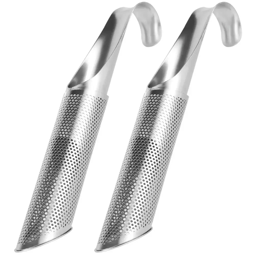 Stainless steel tea infuser on saucer surrounded by dried loose leaf tea