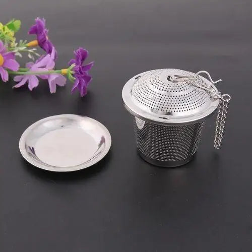 Stainless steel tea infuser in use inside a white ceramic mug