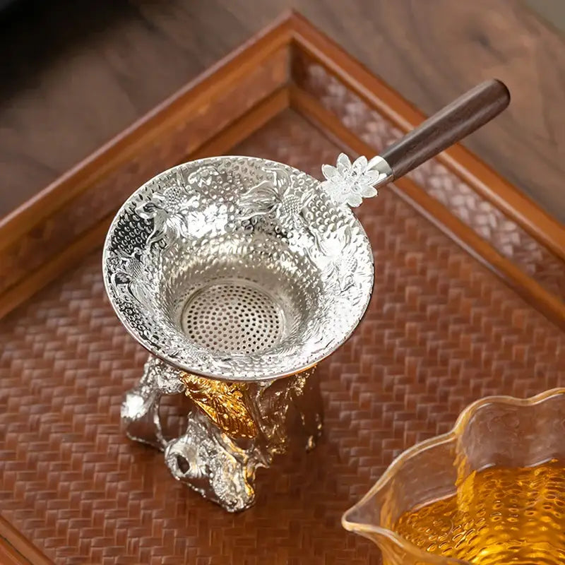 Tea strainer resting on a white ceramic mug
