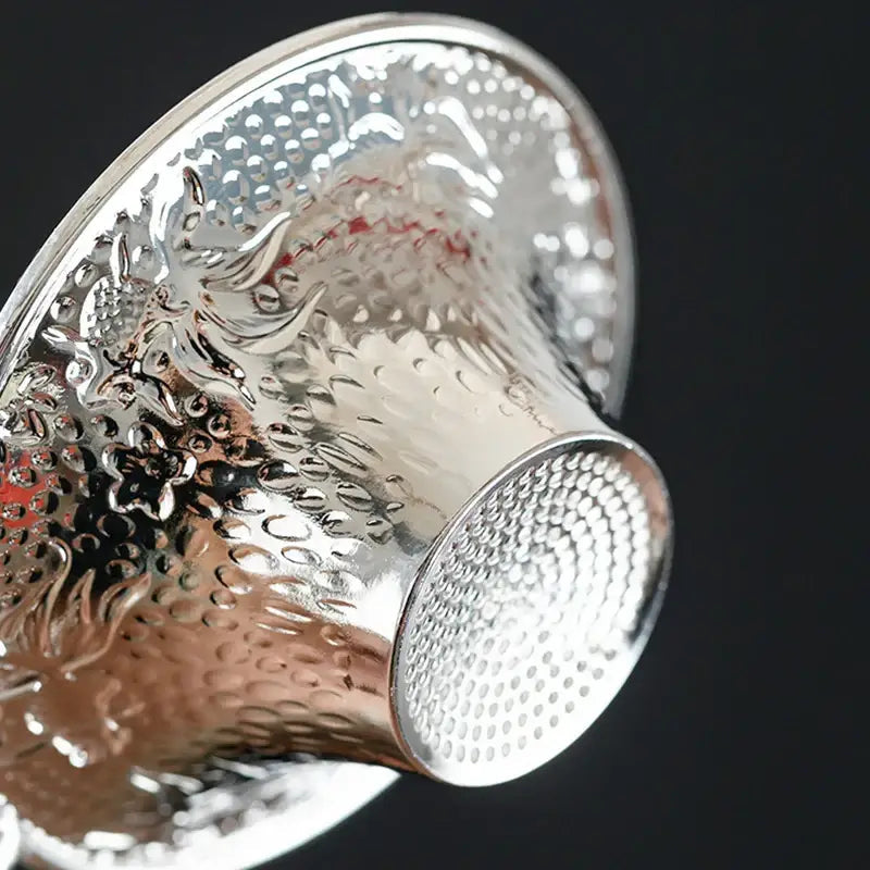 Tea strainer and drip tray on a kitchen counter