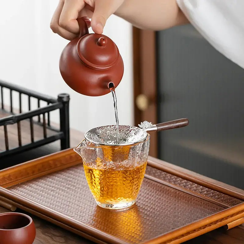 Stainless steel tea strainer held in hand