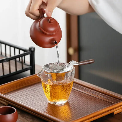 Stainless steel tea strainer held in hand