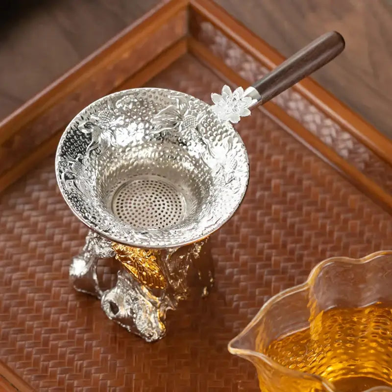Tea strainer with drip tray on a saucer