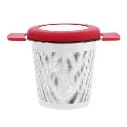 Red stainless steel tea strainer resting over a mug