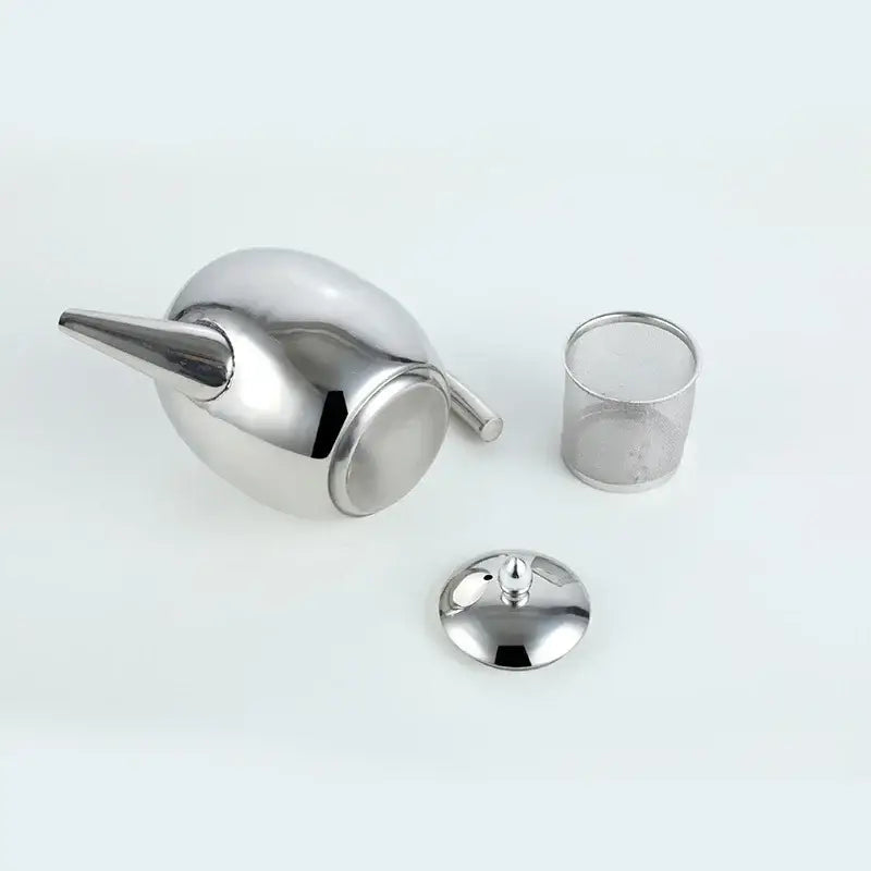 Silver polished stainless steel teapot with steam rising from spout