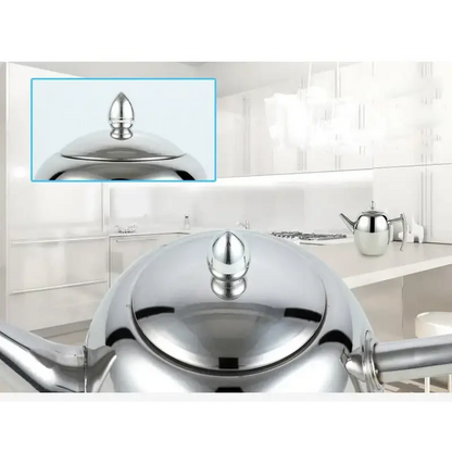 Stainless steel teapot pouring hot water into a teacup