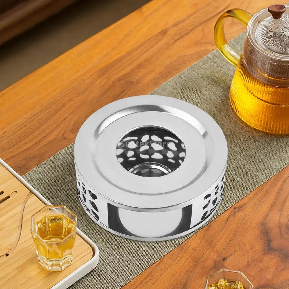 Stainless steel teapot warmer with built-in candle holder, side view