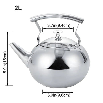 Stainless steel teapot pouring brewed loose-leaf tea into a white cup