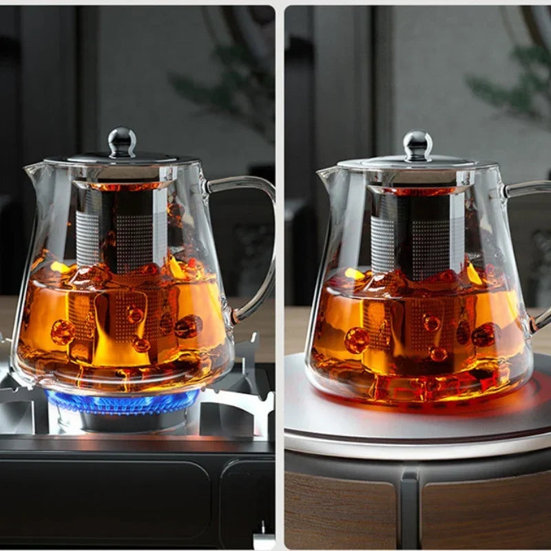 Clear amber tea in a cup next to stainless steel infuser teapot showing brew color