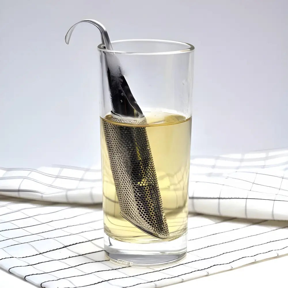 Stainless steel tube tea infuser sitting inside a ceramic mug