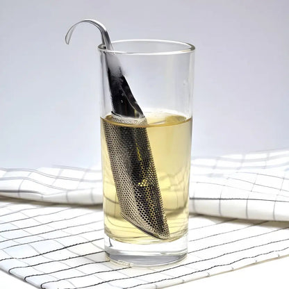 Stainless steel tube tea infuser sitting inside a ceramic mug