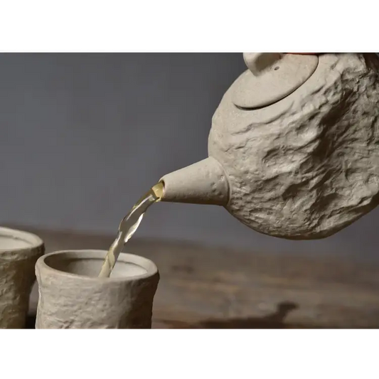 Stone tea set showing teapot and two matching cups from above