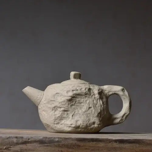 Stone style teapot with lid in place, matte ceramic texture