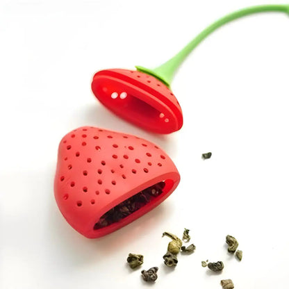 Silicone strawberry tea infuser filled with loose-leaf herbal tea