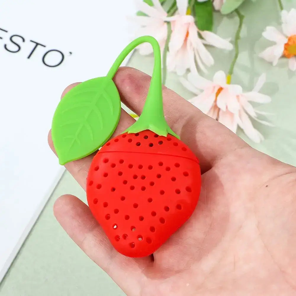 Strawberry tea infuser with tea leaves
