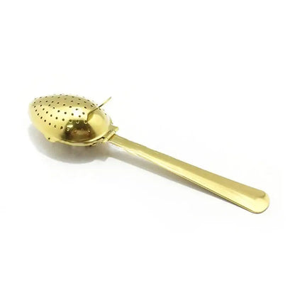Tea infuser spoon resting on mug