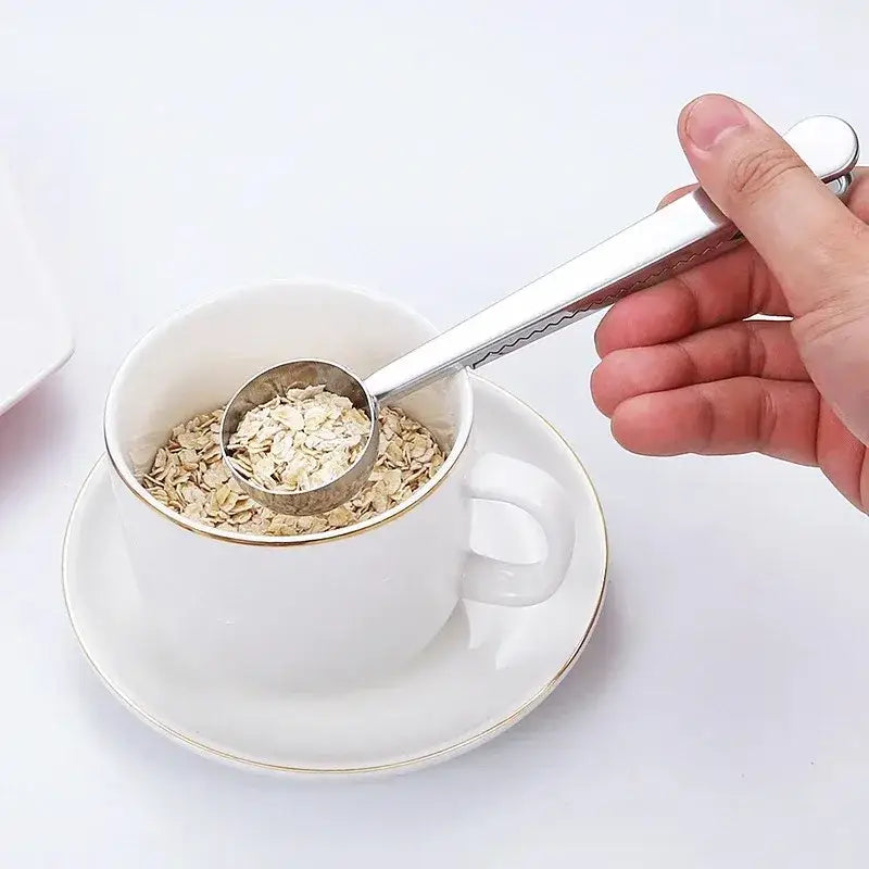 Tea spoon clip holding a tea bag closed