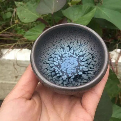Close-up of tenmoku glaze surface on handmade Japanese style ceramic tea cup