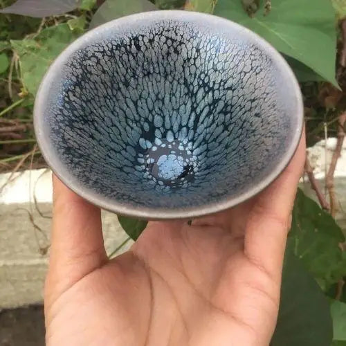 Handcrafted Tenmoku chawan side profile showing amber glaze undertones