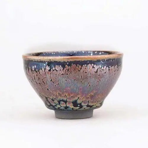 Green matcha powder in traditional Tenmoku stoneware chawan 130 ml