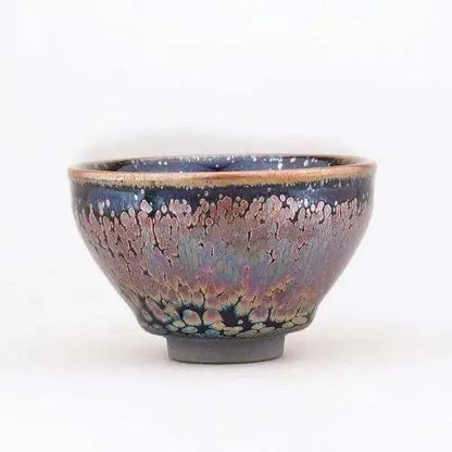 Green matcha powder in traditional Tenmoku stoneware chawan 130 ml