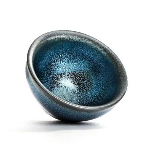 Close-up of tenmoku iron glaze streaks on handmade Japanese ceramic bowl