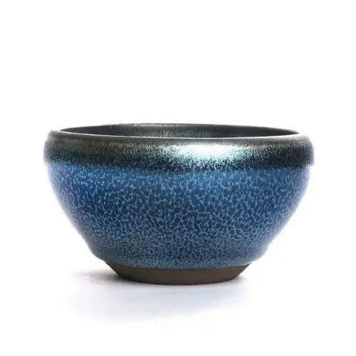 Wide tenmoku chawan bowl with matcha powder inside showing 130 ml capacity
