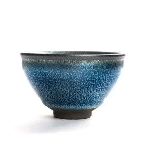 Tall tenmoku matcha bowl shape with bamboo whisk showing deeper profile