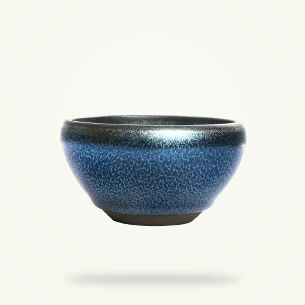 Tenmoku matcha bowl handmade Japanese ceramic chawan on plain background