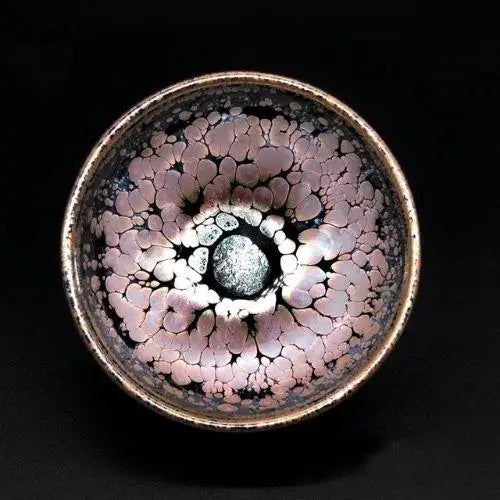 Close-up of Tenmoku tea bowl glaze showing unique iron and rust-gold pattern