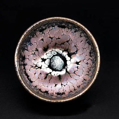Close-up of Tenmoku tea bowl glaze showing unique iron and rust-gold pattern