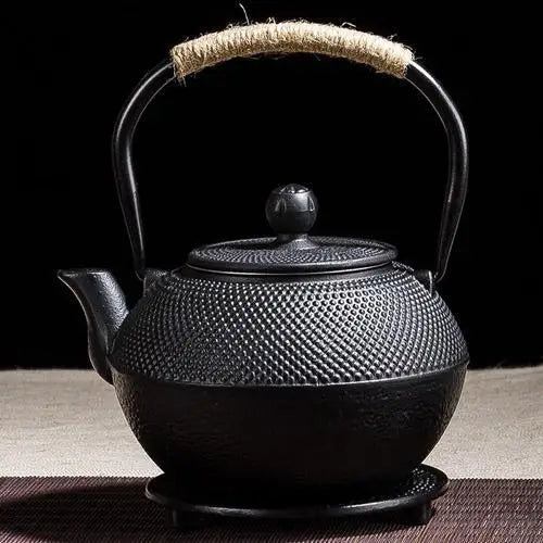 Black cast iron teapot side view