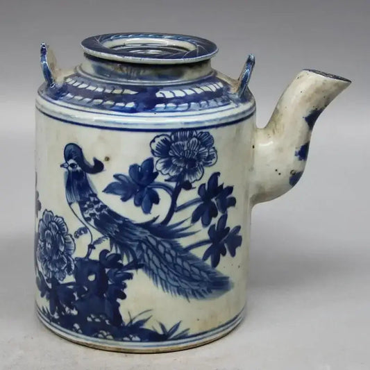 Traditional porcelain teapot with floral motifs on a table