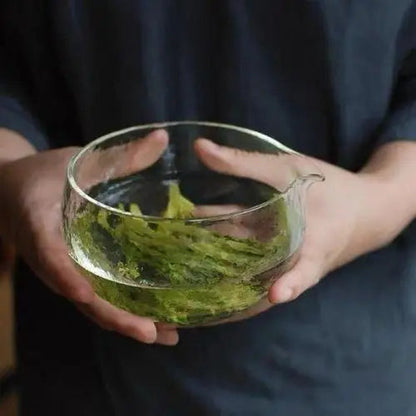 Glass chawan with loose tea leaves inside