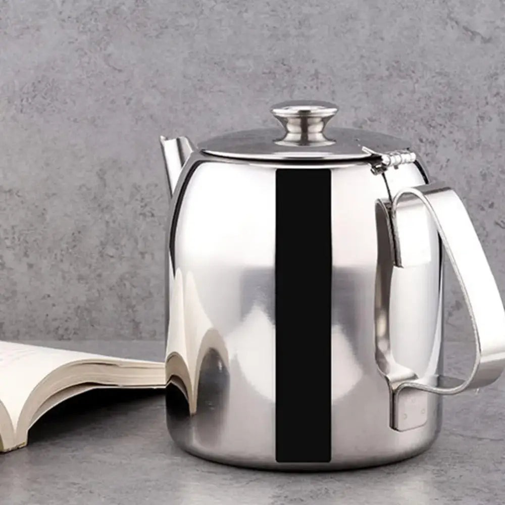 Tunisian steel teapot pouring hot loose leaf tea into glass