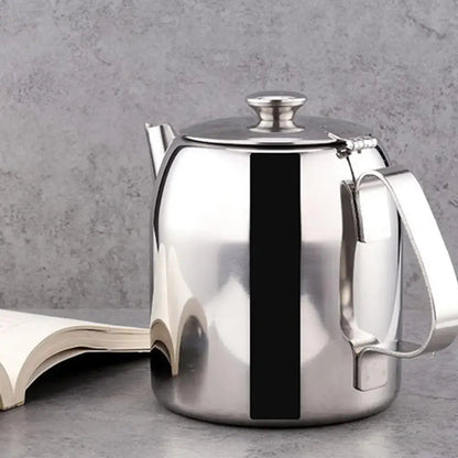 Tunisian steel teapot pouring hot loose leaf tea into glass