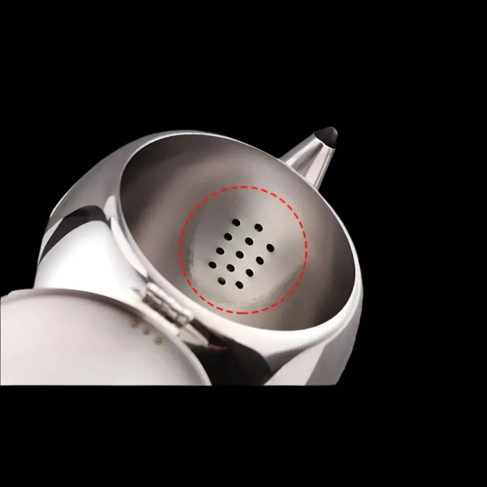 Stainless steel teapot open showing removable strainer and loose tea leaves