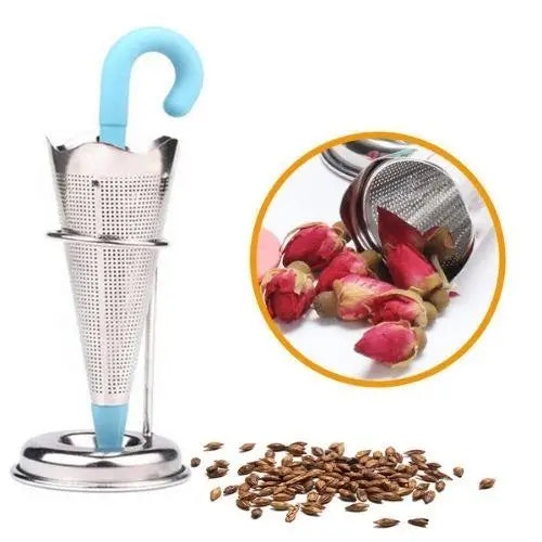 Umbrella loose leaf tea strainer beside dried green tea leaves
