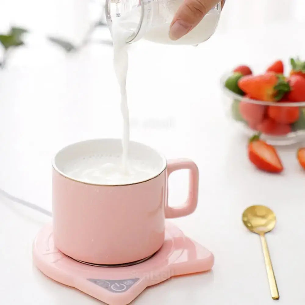 USB cat mug warmer in white keeping tea warm on desk