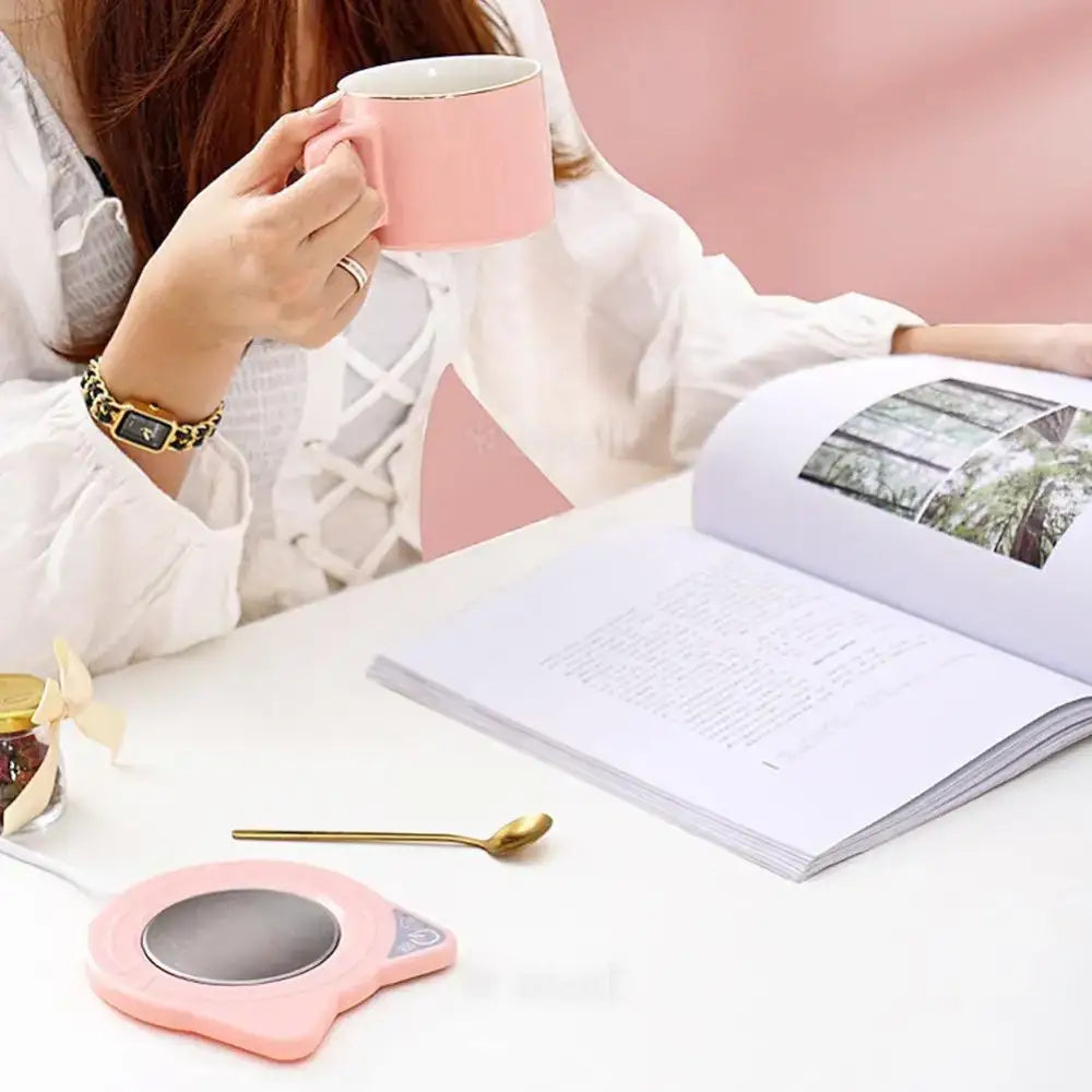 Close-up of USB cat mug warmer showing concave top