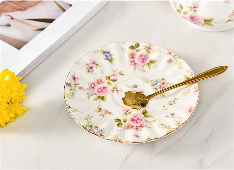 Vintage English porcelain tea set with cups, saucers, teapot, and gold stand