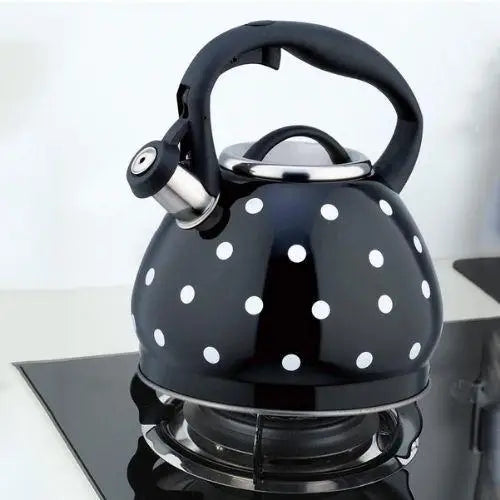 3.5-liter vintage polka dot tea kettle sitting on lit gas burner in kitchen