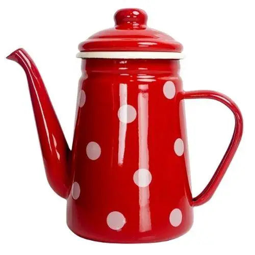 Red polka dot enamel kettle sitting on lit gas stove burner