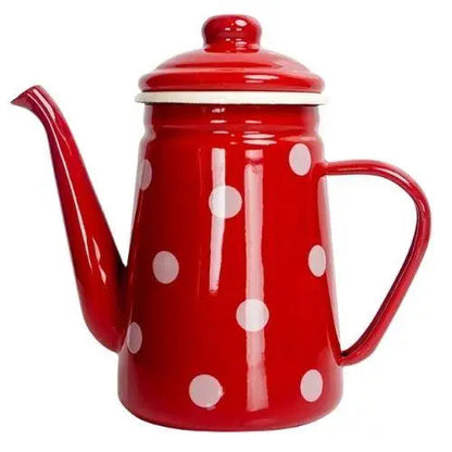 Red polka dot enamel kettle sitting on lit gas stove burner